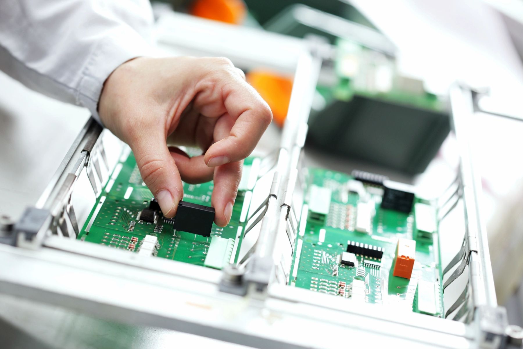 Technician inspecting a precision circuit board assembly