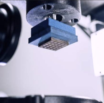 Stamping head positioned over a patterned substrate during a production run